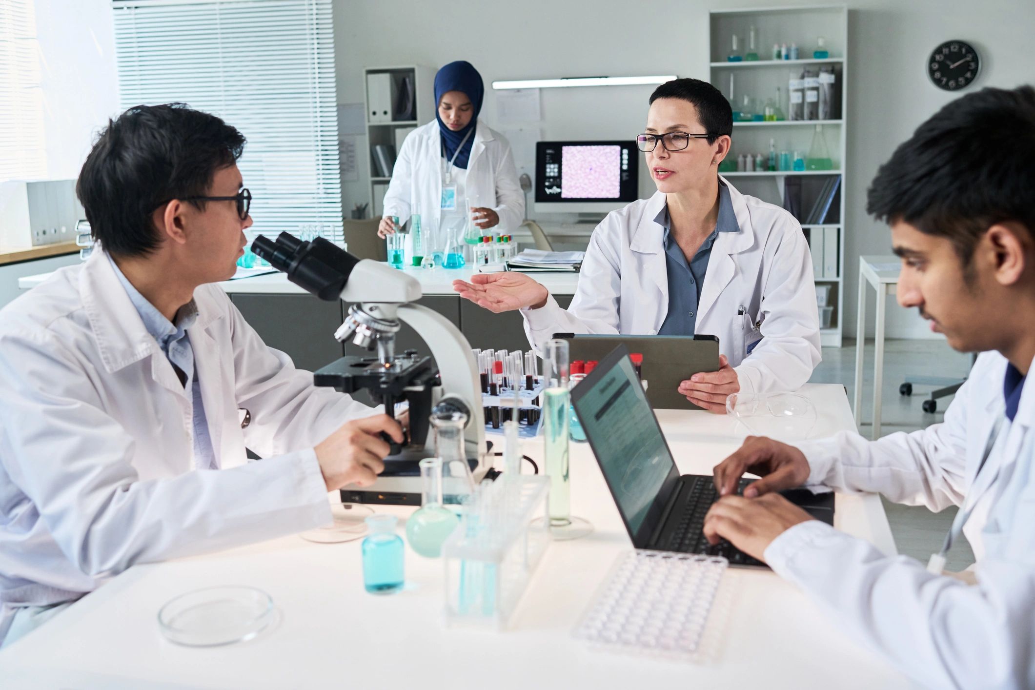 Biotech team discussing research findings in a laboratory