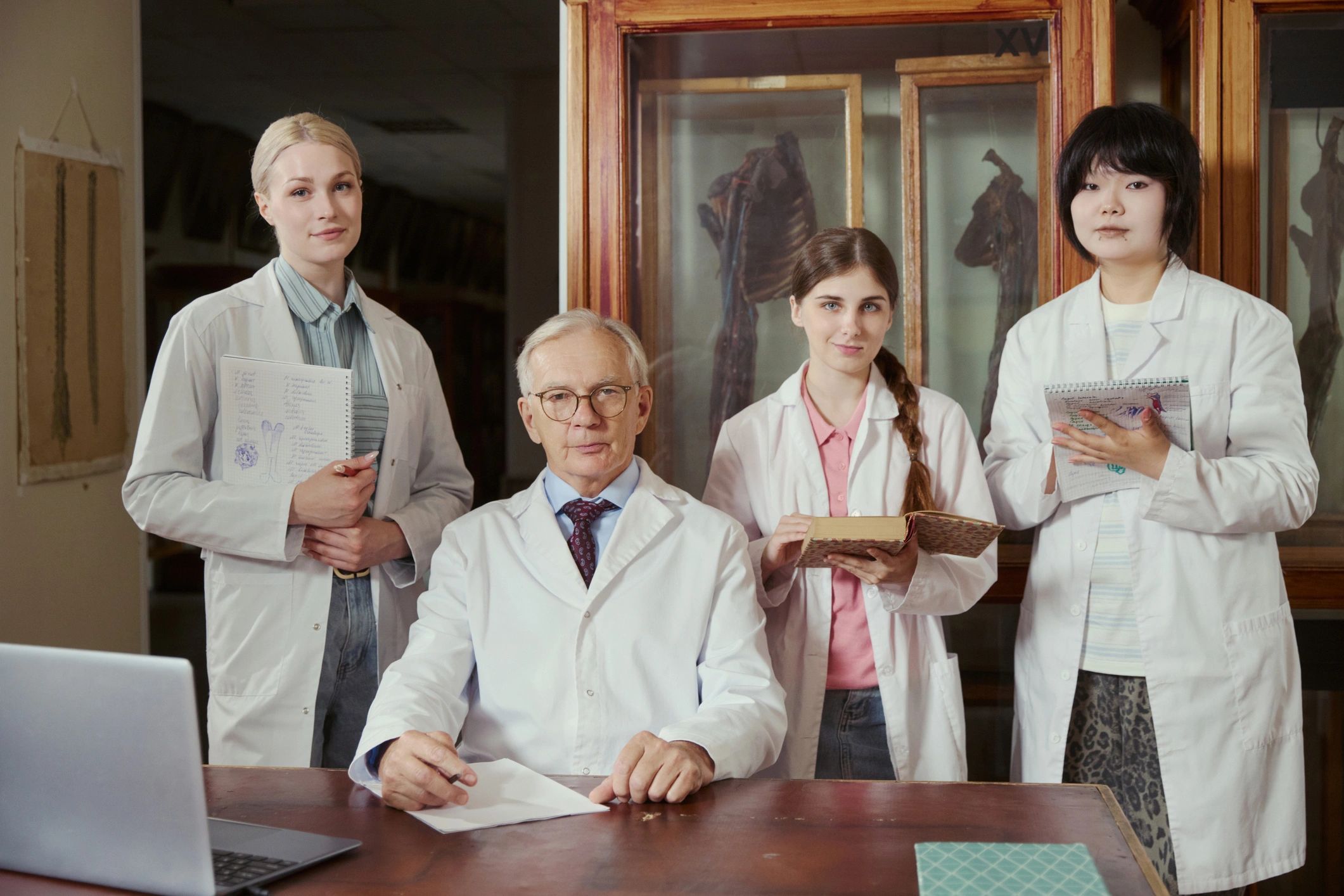 Professor and medical students in anatomy lab